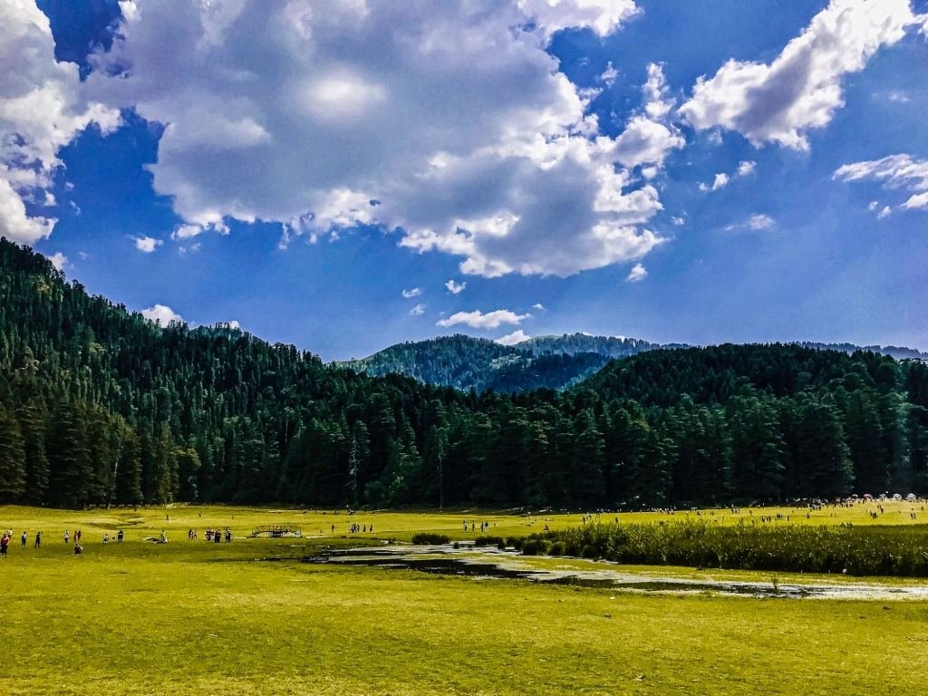 The green Khajjiar meadow ringed by deodar forest near Dalhousie